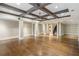 Spacious basement with beautiful hardwood floors, coffered ceilings, and custom built-in shelving for storage and display at 4755 Columns Se Dr, Marietta, GA 30067