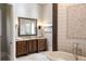 Elegant bathroom features a soaking tub and a dark wood vanity with decorative mirror at 4755 Columns Se Dr, Marietta, GA 30067