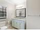 Bright bathroom with a granite countertop, blue vanity, and tile floors at 4755 Columns Se Dr, Marietta, GA 30067