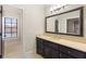 Bathroom featuring a dark vanity, large mirror, and tile flooring at 4755 Columns Se Dr, Marietta, GA 30067