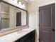 Bathroom vanity with a white countertop, mirror, and dark brown cabinets at 4755 Columns Se Dr, Marietta, GA 30067