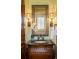 Elegant bathroom vanity features granite countertop, framed mirror, and decorative sconces at 4755 Columns Se Dr, Marietta, GA 30067