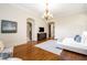 Sun-filled bedroom with hardwood floors, TV, and a view of adjoining rooms at 4755 Columns Se Dr, Marietta, GA 30067