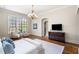 Relaxing bedroom featuring hardwood floors, accent chairs, and a flat-screen TV at 4755 Columns Se Dr, Marietta, GA 30067