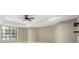 Bedroom with neutral walls, window with blinds, and a tray ceiling with a ceiling fan at 4755 Columns Se Dr, Marietta, GA 30067
