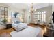 Spacious bedroom features hardwood floors, neutral paint, large windows, and a decorative chandelier at 4755 Columns Se Dr, Marietta, GA 30067