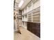 Spacious walk-in closet with custom shelving, drawers, and a rolling ladder at 4755 Columns Se Dr, Marietta, GA 30067