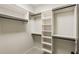 Walk-in closet featuring custom white shelving with black metal rods for organized storage at 4755 Columns Se Dr, Marietta, GA 30067