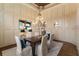 Formal dining room with decorative wall paneling and a stylish chandelier at 4755 Columns Se Dr, Marietta, GA 30067