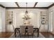 Dining room with a chandelier, built-in shelving, hardwood floors, and a large table at 4755 Columns Se Dr, Marietta, GA 30067