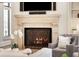 Close-up of living room fireplace with stone mantel, decorative screen, and built-in shelving at 4755 Columns Se Dr, Marietta, GA 30067
