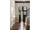 Elegant foyer with dark wood floors, staircase, and entry door with transom window at 4755 Columns Se Dr, Marietta, GA 30067