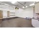 Bright garage featuring built-in shelving, a utility sink, and ample storage space for tools and equipment at 4755 Columns Se Dr, Marietta, GA 30067