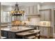 Well-lit kitchen with stone countertops, kitchen island with seating, and ample cabinet storage at 4755 Columns Se Dr, Marietta, GA 30067