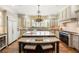 Spacious kitchen featuring custom cabinets, granite countertops, and stainless steel appliances at 4755 Columns Se Dr, Marietta, GA 30067