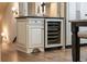 Kitchen with a wine refrigerator, tiled floor, and custom cabinets at 4755 Columns Se Dr, Marietta, GA 30067