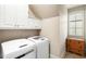 Convenient laundry room with a washer, dryer, and storage cabinets at 4755 Columns Se Dr, Marietta, GA 30067