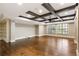 Spacious living room with hardwood floors, coffered ceiling, and abundant natural light at 4755 Columns Se Dr, Marietta, GA 30067
