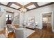 Elegant living room with hardwood floors, coffered ceiling, and a curved staircase at 4755 Columns Se Dr, Marietta, GA 30067
