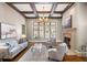 Bright living room with coffered ceiling, stone fireplace, and large picture window at 4755 Columns Se Dr, Marietta, GA 30067