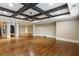 Large living area with hardwood floors, coffered ceiling, and elegant architectural details at 4755 Columns Se Dr, Marietta, GA 30067