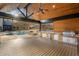 Luxurious outdoor kitchen and poolside area with built-in grill and wood ceiling at 4755 Columns Se Dr, Marietta, GA 30067