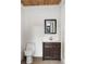 Stylish powder room with white paneling, marble countertop and dark wood cabinet at 4755 Columns Se Dr, Marietta, GA 30067