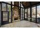 Inviting sunroom featuring stone fireplace, floor-to-ceiling windows, and cozy atmosphere at 4755 Columns Se Dr, Marietta, GA 30067