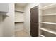 Spacious walk-in closet features built-in shelving and hanging rods at 4755 Columns Se Dr, Marietta, GA 30067