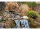 Intimate garden waterfall with beautiful landscaping and mature plantings at 4755 Columns Se Dr, Marietta, GA 30067