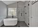 Bathroom featuring a freestanding tub, frameless glass shower with rainfall showerhead and modern finishes at 2157 Capella Sw Cir, Atlanta, GA 30331