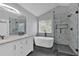 Modern bathroom with dual vanity, freestanding tub, frameless glass shower, and elegant finishes at 2157 Capella Sw Cir, Atlanta, GA 30331