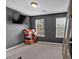 Bedroom with carpet, natural light from two windows, and a TV mounted on the wall at 2157 Capella Sw Cir, Atlanta, GA 30331