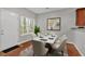 Bright dining area with a white table, seating for six, and a door leading to the outdoors at 2157 Capella Sw Cir, Atlanta, GA 30331