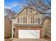 Charming two-story home features a brick-accented garage, brown siding, and inviting curb appeal at 2157 Capella Sw Cir, Atlanta, GA 30331