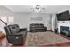 Spacious living room with a fireplace, hardwood floors, large windows, and comfortable seating at 2157 Capella Sw Cir, Atlanta, GA 30331