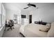 Bright bedroom with windows, a ceiling fan, a desk, and a comfortable bed with stylish pillows and a bedspread at 3208 Sonnet Se Walk, Atlanta, GA 30339