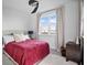 Bright bedroom featuring a ceiling fan, window and a comfortable bed with a red quilt at 3208 Sonnet Se Walk, Atlanta, GA 30339