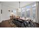 Dining room features a large wooden table, modern chandelier, and bright windows at 3208 Sonnet Se Walk, Atlanta, GA 30339