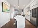 Sleek kitchen featuring a large island, modern stainless steel appliances, and dark hardwood flooring at 3208 Sonnet Se Walk, Atlanta, GA 30339