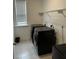 Practical laundry room with modern black washer and dryer units and convenient shelving at 3208 Sonnet Se Walk, Atlanta, GA 30339