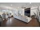 Spacious living room featuring a large sectional, fireplace with TV, and hardwood floors for a cozy atmosphere at 3208 Sonnet Se Walk, Atlanta, GA 30339