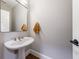 Bright bathroom featuring a pedestal sink, modern mirror, and neutral colors at 3491 Roswell Ne Rd, Atlanta, GA 30305