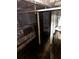 Flooded basement featuring support columns, exposed piping, and water heater at 1771 Hosea L Williams Se Dr, Atlanta, GA 30317