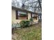 Exterior view of a house with boarded windows and a neglected yard at 1771 Hosea L Williams Se Dr, Atlanta, GA 30317