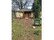 A view of a yellow home with missing siding and a dilapidated structure at 1771 Hosea L Williams Se Dr, Atlanta, GA 30317