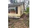 Side of the house with weathered siding, boarded windows and an overgrown yard at 1771 Hosea L Williams Se Dr, Atlanta, GA 30317