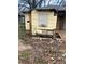 A deteriorated yellow home with boarded windows and visible damage to the siding and foundation at 1771 Hosea L Williams Se Dr, Atlanta, GA 30317