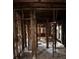 Interior shot of gutted home with exposed studs, missing drywall, and damaged flooring throughout the space at 1771 Hosea L Williams Se Dr, Atlanta, GA 30317
