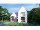 Beautiful white brick house with modern architecture and a well-kept lawn, nestled among mature trees at 570 Belada Blvd, Sandy Springs, GA 30342